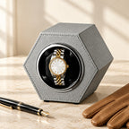 Hexagon single watch winder beside a fountain pen and leather gloves