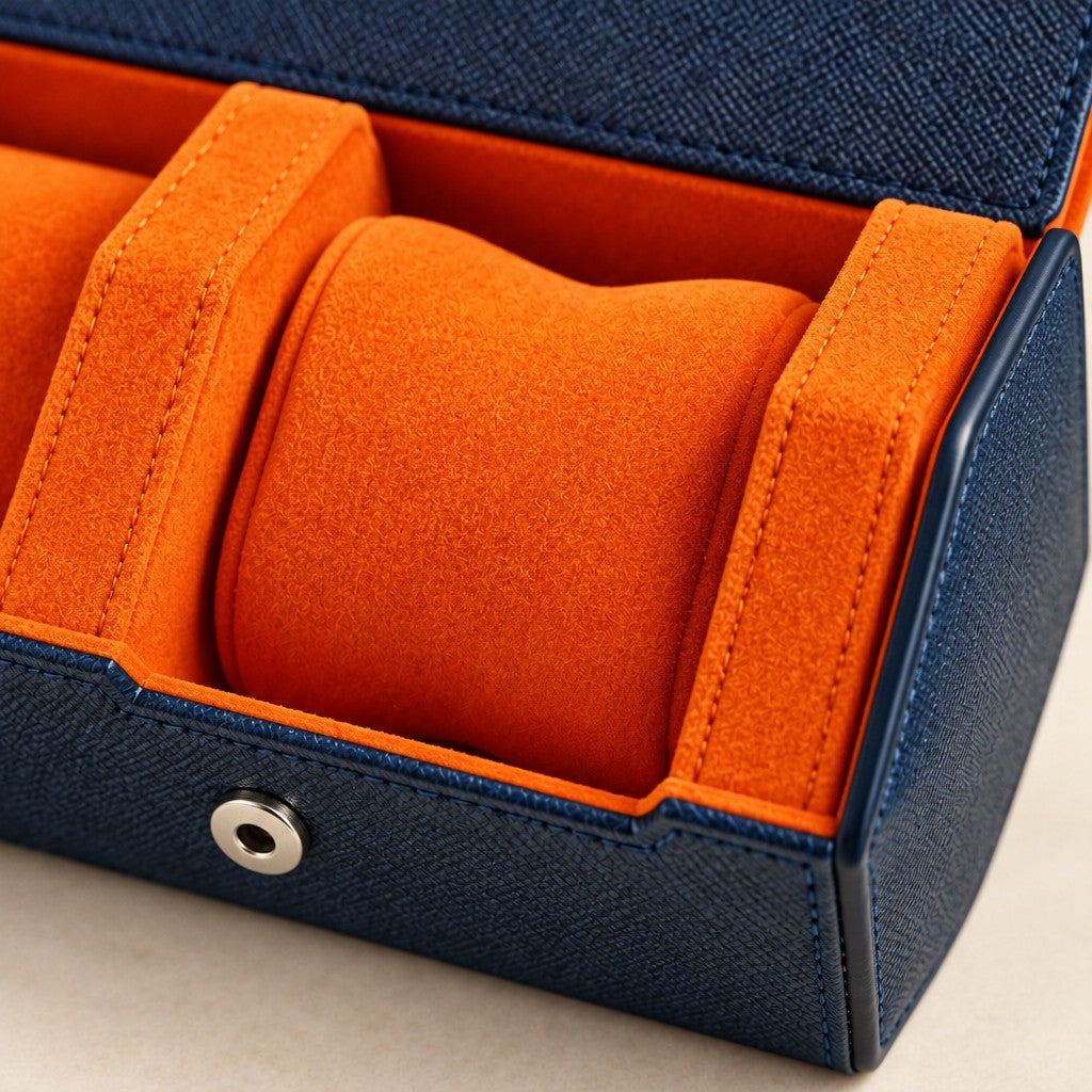 Hexagonal 3-slot watch case in navy with orange interior, close-up of the materials and finish