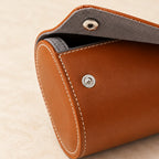Close-up of the contrast stitching, a snap stud and a gray suede-touch pillow