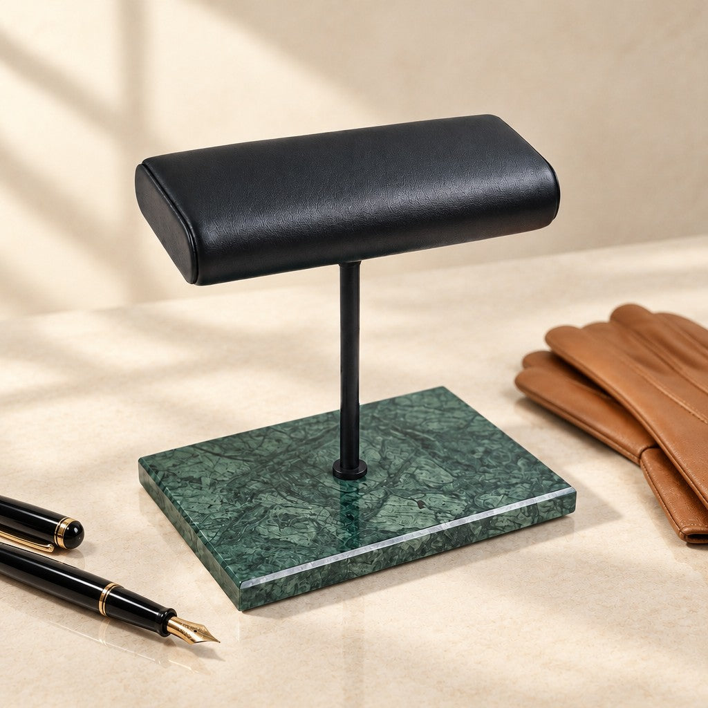 Green marble wide pillow stand beside a fountain pen and leather gloves