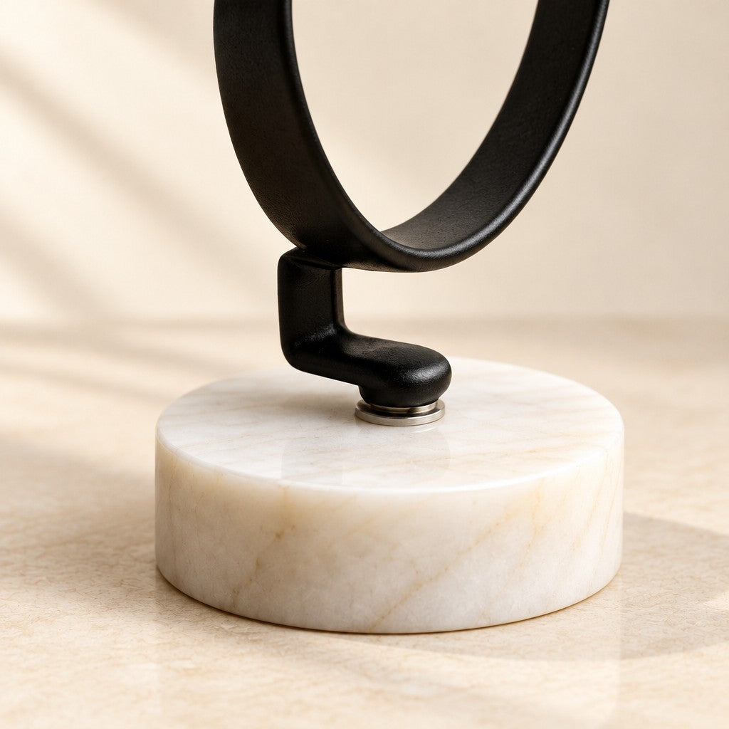 Close-up of the marble base c-ring watch stand materials and finish