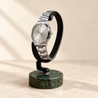 C-ring watch stand on a green marble base