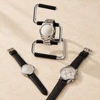 Bent-metal stand with a 42 mm watch, a 36 mm and a 45 mm watch beside it
