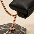Close-up of the leather cushion and the curved metal hook