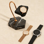 Marble hook stand with a 42 mm watch, a 36 mm and a 45 mm watch beside it