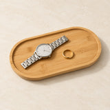 Oval bamboo valet tray holding a watch and a ring