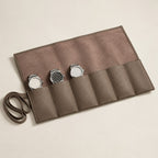 Khaki 6-slot leather watch roll laid open with three watches