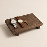Rustic wooden valet riser holding two watches and a key