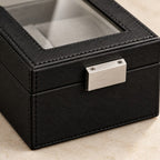 Close-up of the glass window, stitching and metal clasp of the single watch box