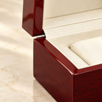 Close-up of the red lacquer and cream padded lining of the single watch box