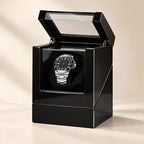 Black gloss single watch winder with the lid open and an automatic watch on the pillow