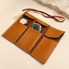 Tan genuine leather watch roll open, with two watches in its pockets