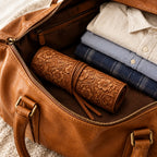 Tooled cowhide leather watch roll with 4 pockets, in an open leather weekender bag