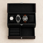 Top view of the two-tier carbon-pattern watch box with watches of different sizes