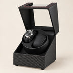USB double watch winder in carbon-pattern finish, lid open with one watch