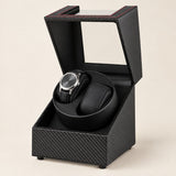 USB double watch winder in carbon-pattern finish, lid open with one watch