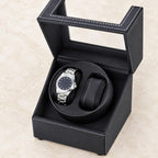 Top view of the open double watch winder with one watch on its pillow