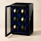 Black 12-watch winder cabinet with the glass door open and six watches