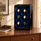 12-watch winder cabinet on a wooden chest of drawers beside a valet tray and a book