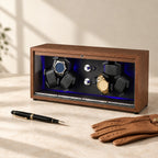 Walnut 6-watch winder closed, beside a fountain pen and leather gloves