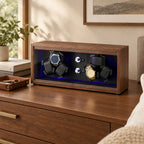 Walnut 6-watch winder on a wooden dresser beside a valet tray and books