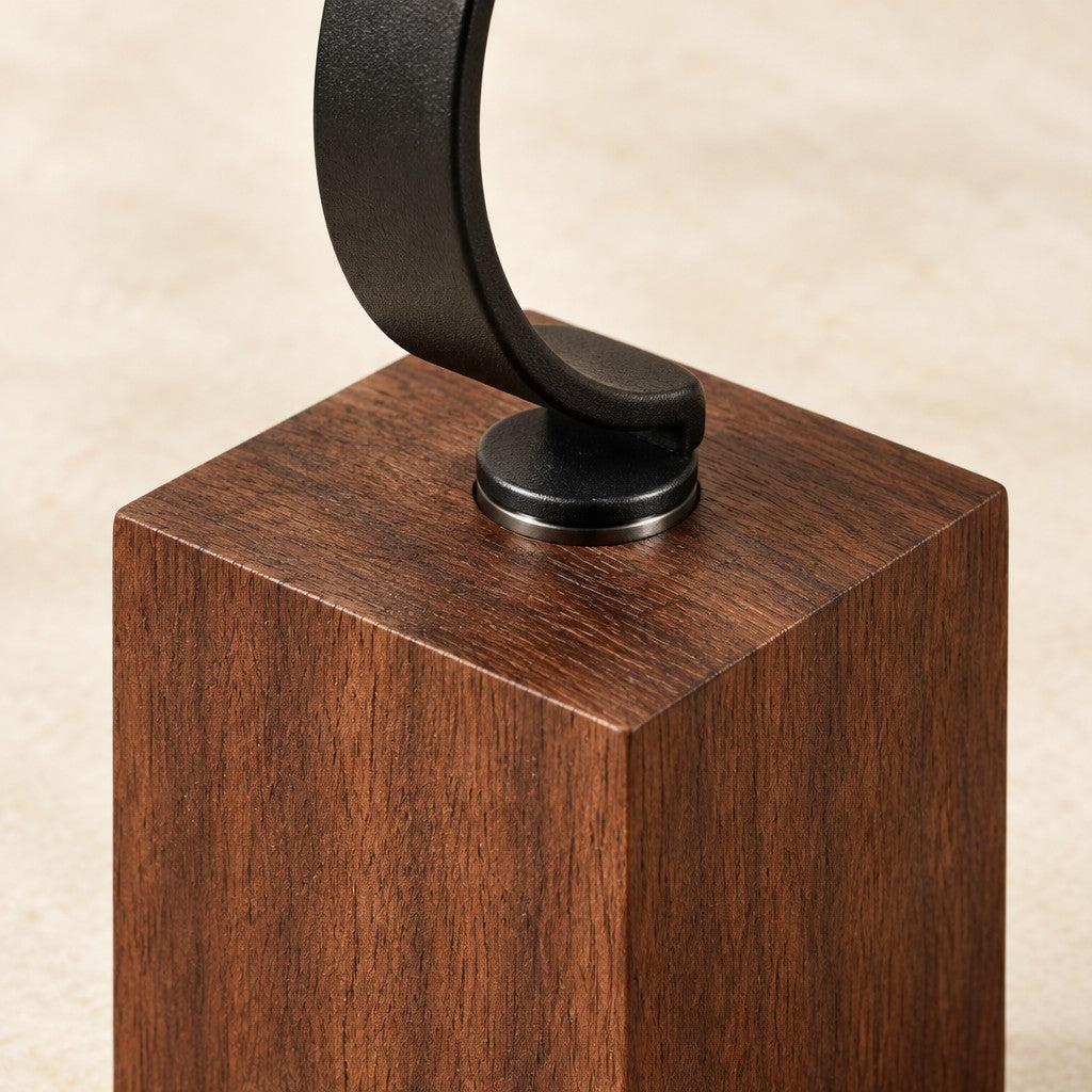Close-up of the black metal hook fixed into the walnut block