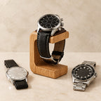 Wooden watch stand holding a 45 mm chronograph, with a 36 mm and a 42 mm watch beside it