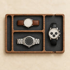 Wooden nightstand valet tray with felt-lined compartments, from above, with watches of different sizes